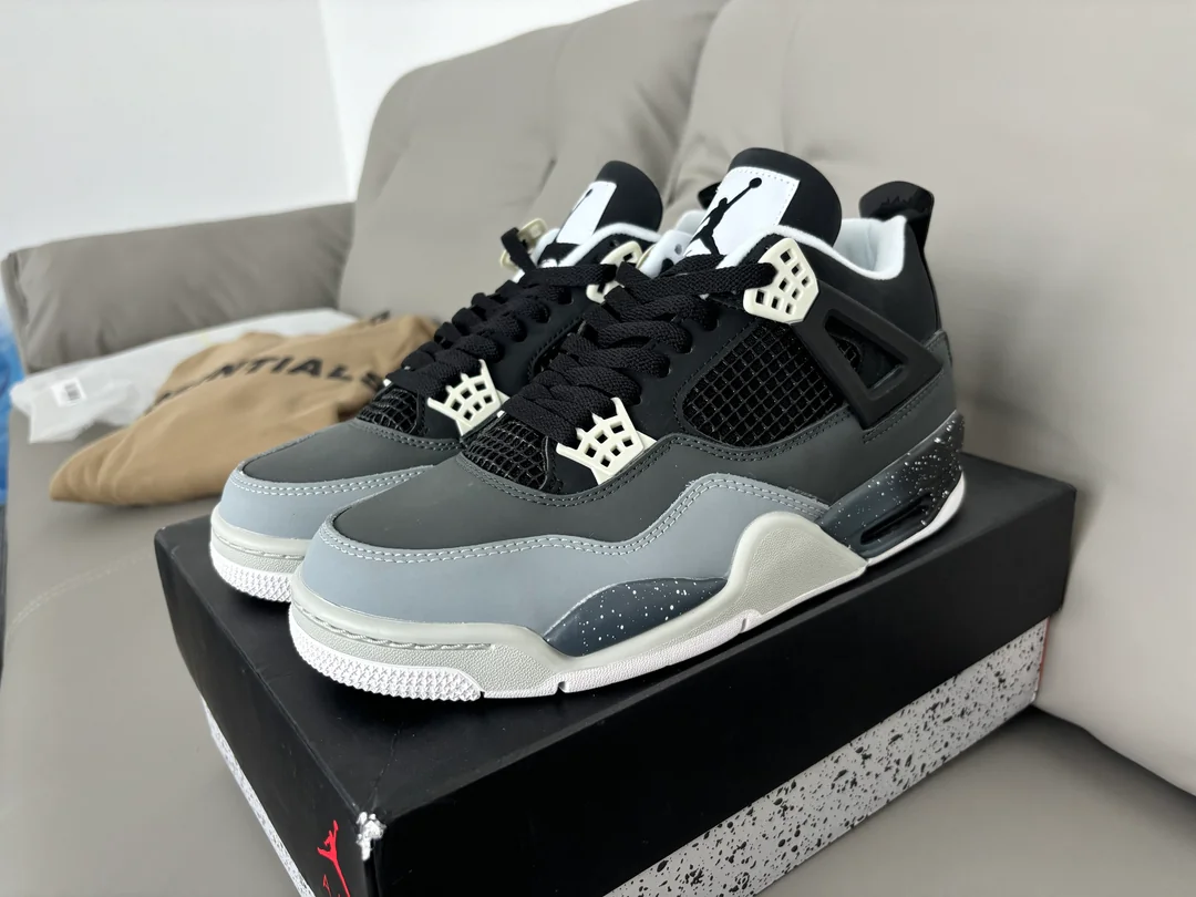 Front three-quarter view of the grey and black high-top sneakers