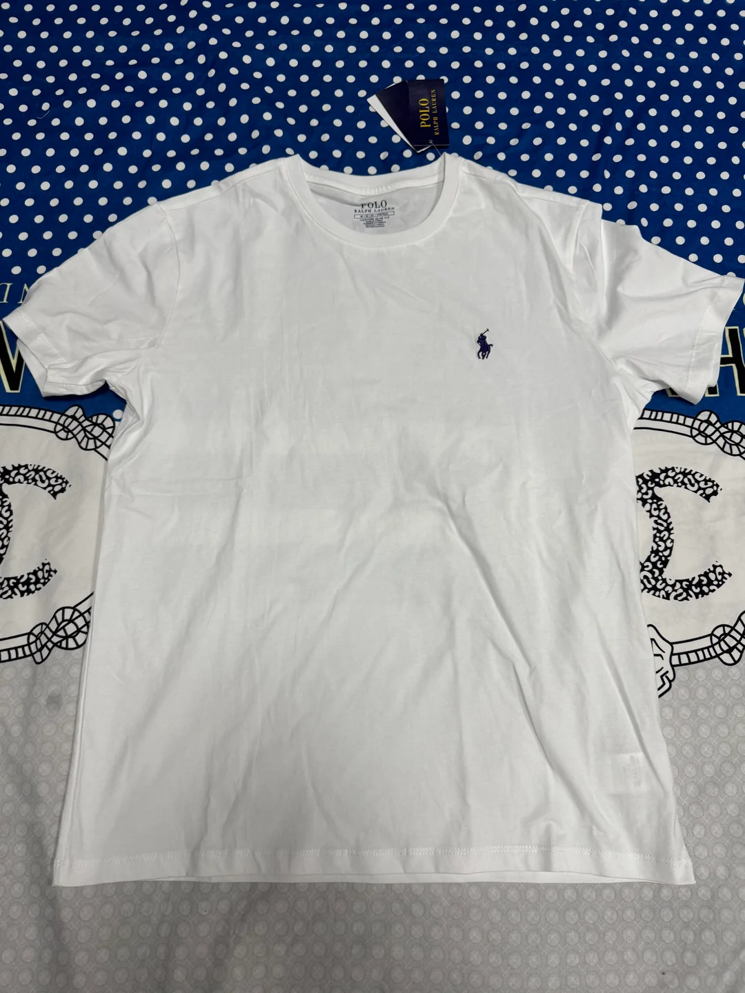 White polo shirt photographed after delivery in the United Kingdom